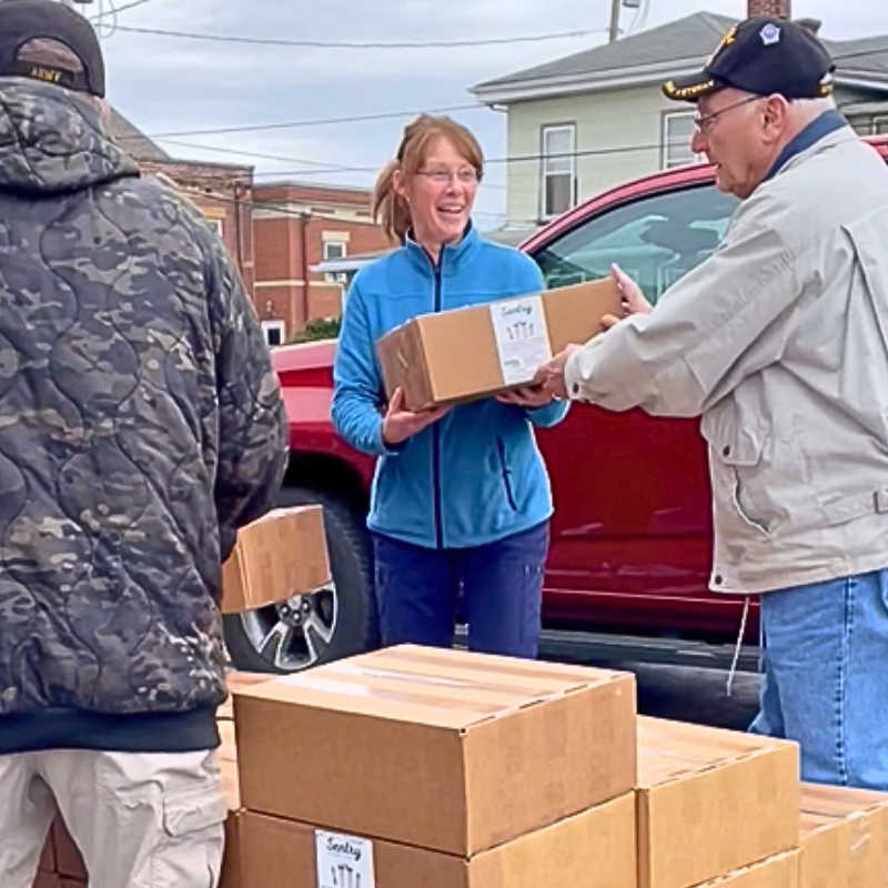 Volunteers distributing boxes of water filters